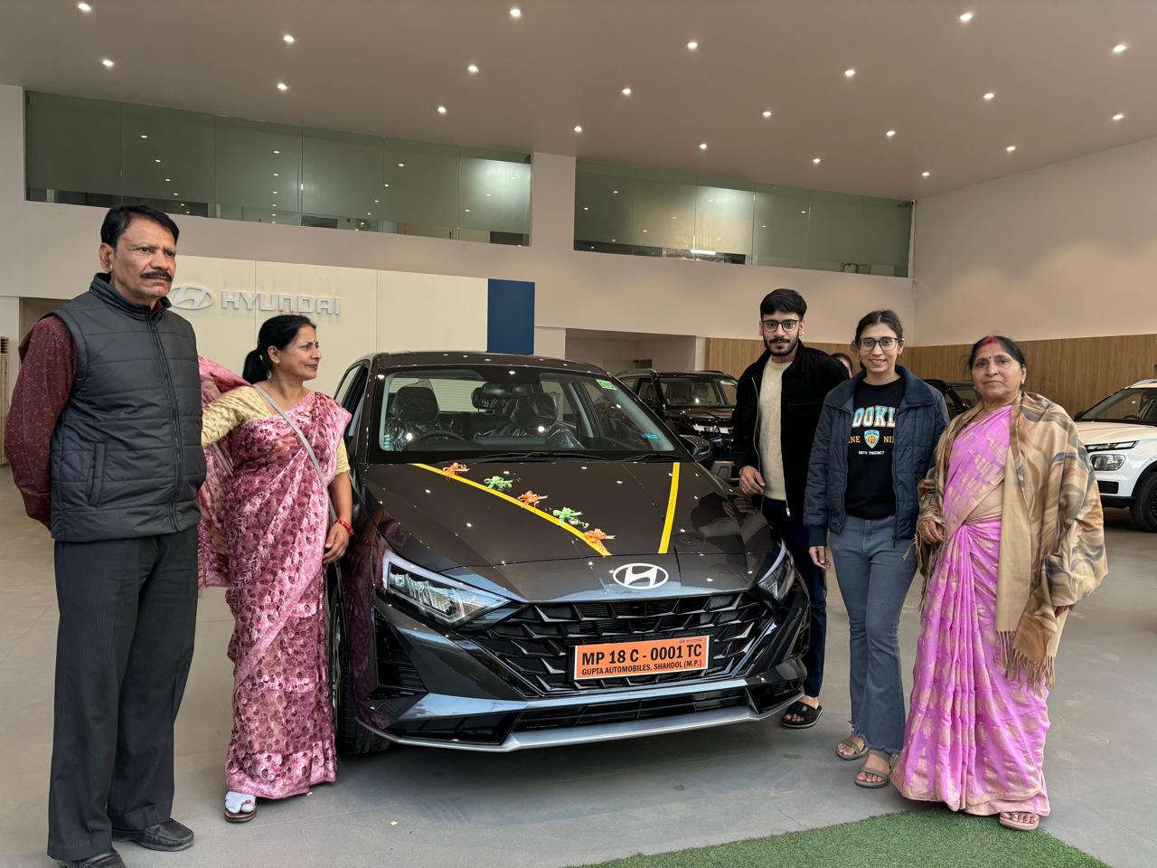 Yogi & Sudha — family at car delivery